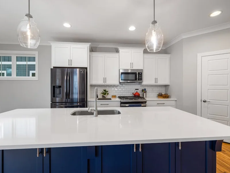 Stylish modern kitchen with a spacious white countertop and stainless steel appliances