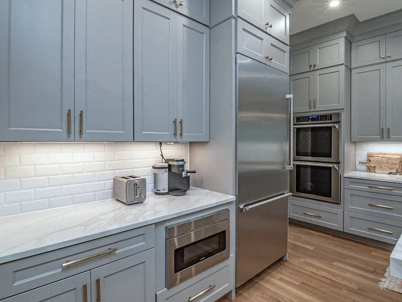 Sleek modern kitchen featuring stainless steel appliances and light grey cabinets