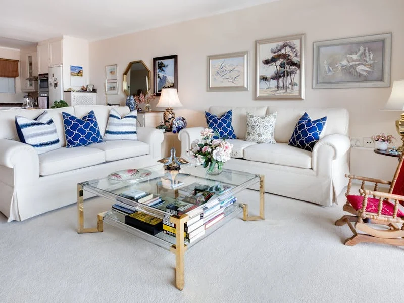 Modern living room with stylish decor and comfortable white sofas.