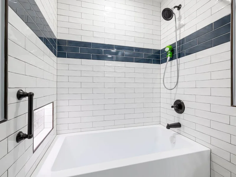 Sleek, minimalist bathroom with white and blue tiles and contemporary fixtures