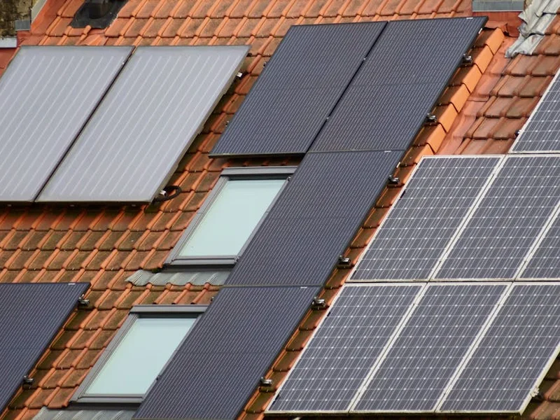 Close-up of solar panels on a tiled roof, showcasing sustainable energy solutions.